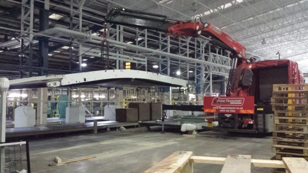 Crane lifting equipment inside a live factory