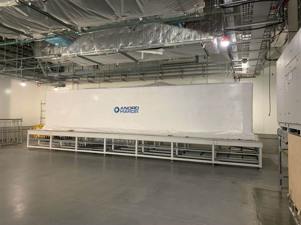 large white machine inside a factory