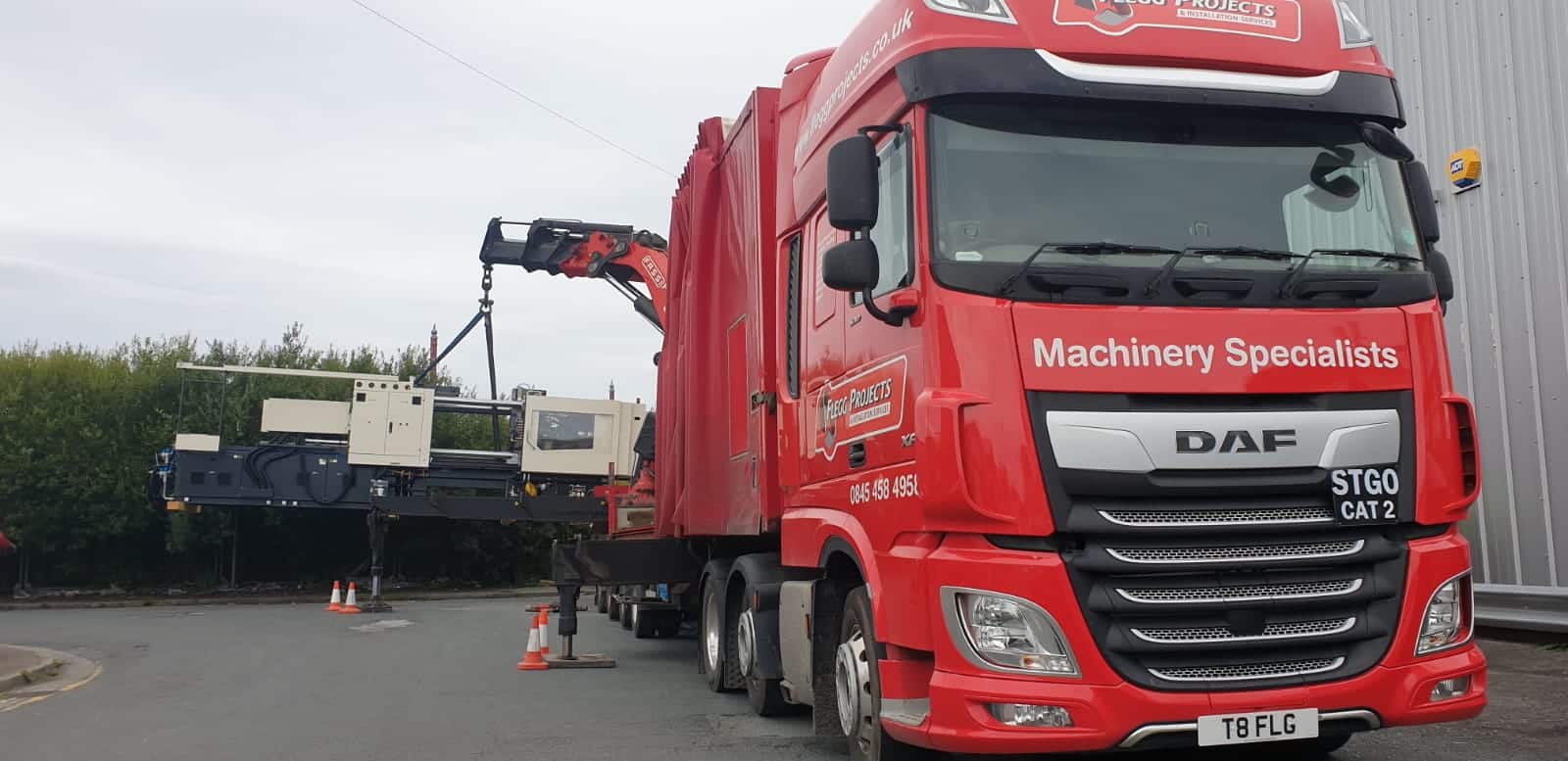 red truck moving plastics and rubber machinery