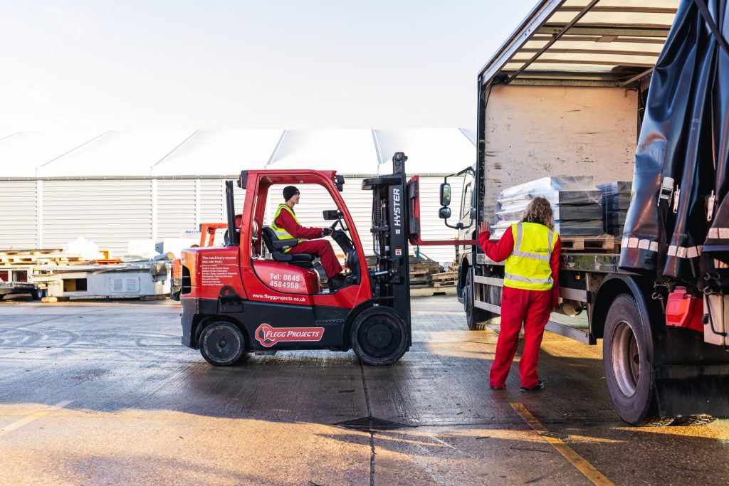 forklift taking equipment off truck