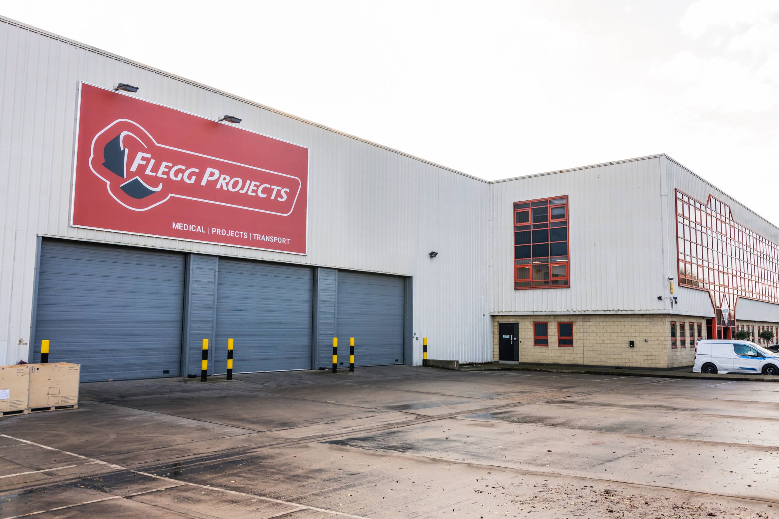 Flegg logo on white warehouse facing