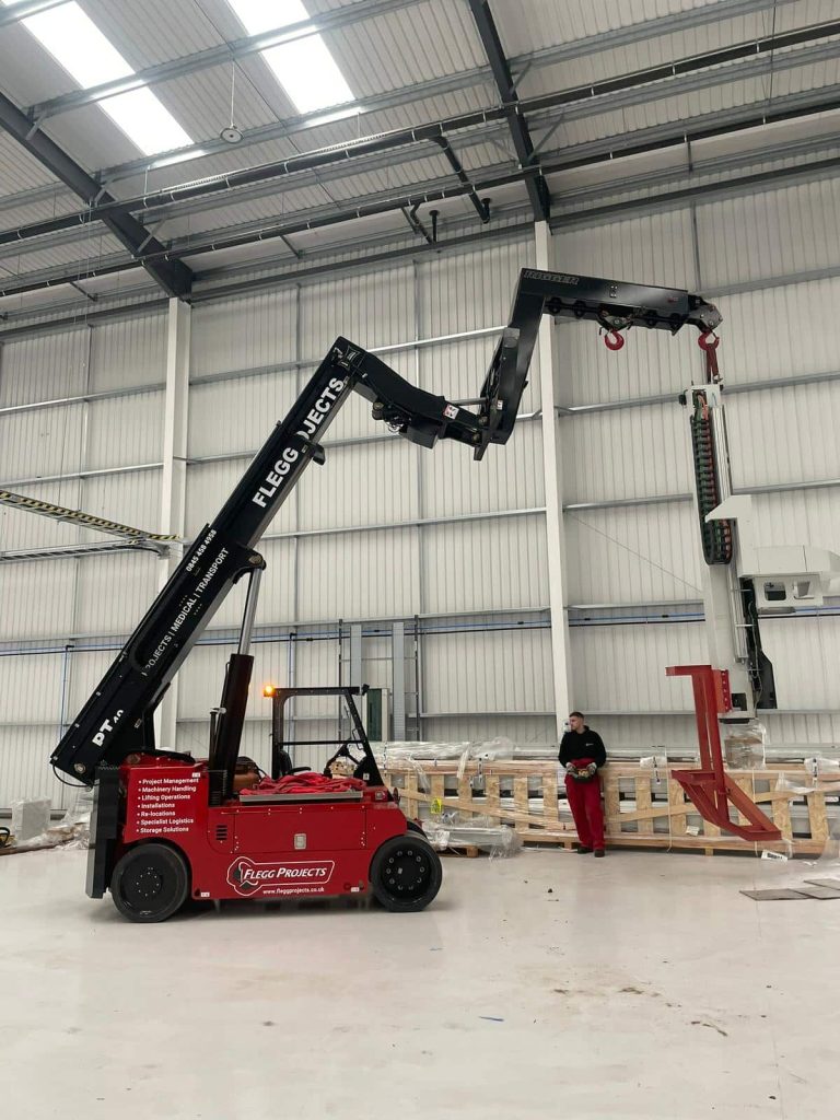 Large routing machine being moved inside a warehouse