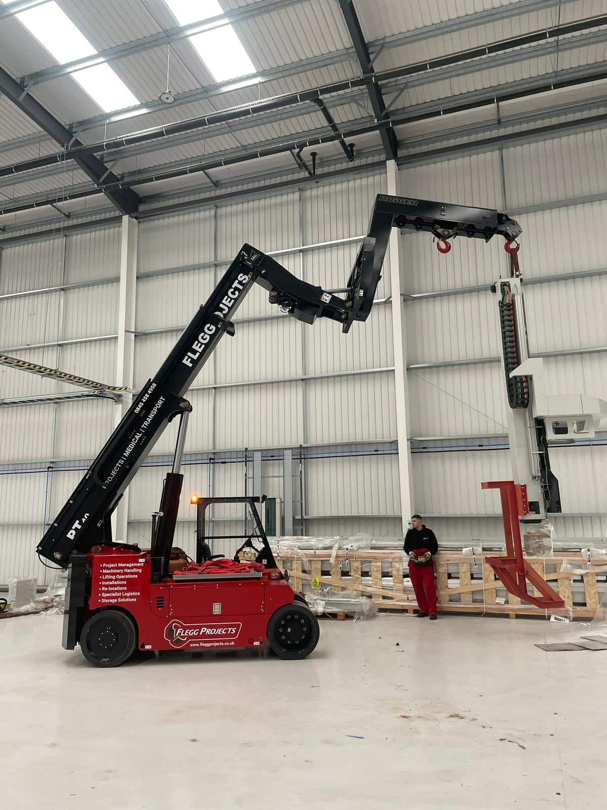 Large routing machine being moved inside a warehouse